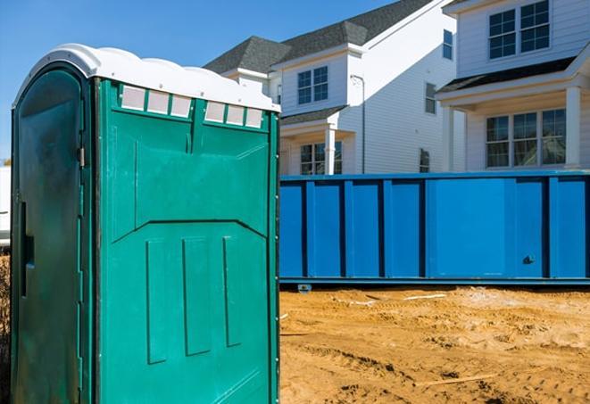 a sea of portable toilets at a job site